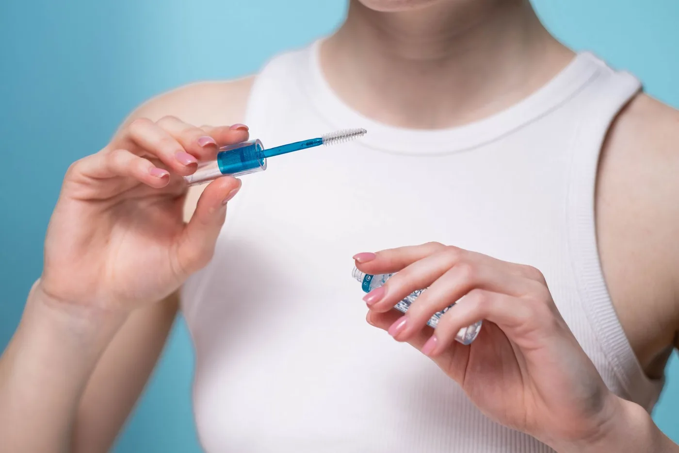 Applying the best eyebrow gel with a wand and spoolie brush