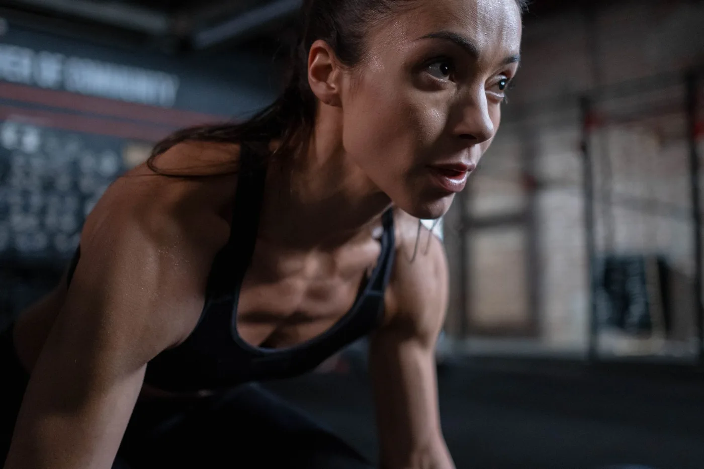 Woman mid-workout at the gym, testing sweatproof eyebrow gel hold